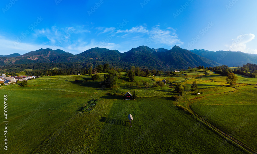 Aerial view. Mountains and buildings city, road, summer day sunset. Travel and tourism. green hills. Bohinjska Bistrica Slovenia, Triglav