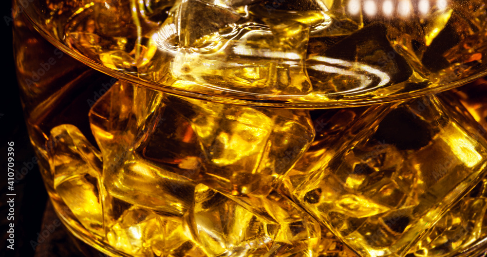 detail of glass with alcoholic drink, spot focus. Drink with malt and ice detail of glass with alcoholic drink, spot focus. Drink with malt and ice