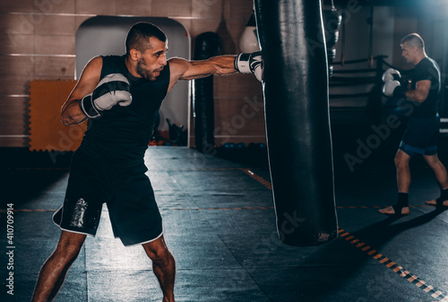 Portrait of a confident young professional boxer in the garage