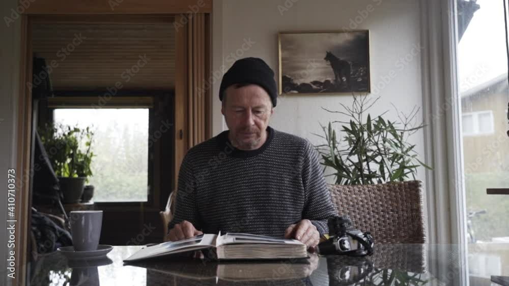 Man In Woolly Hat Closing Photograph Album Man In Woolly Hat Closing Photograph Album