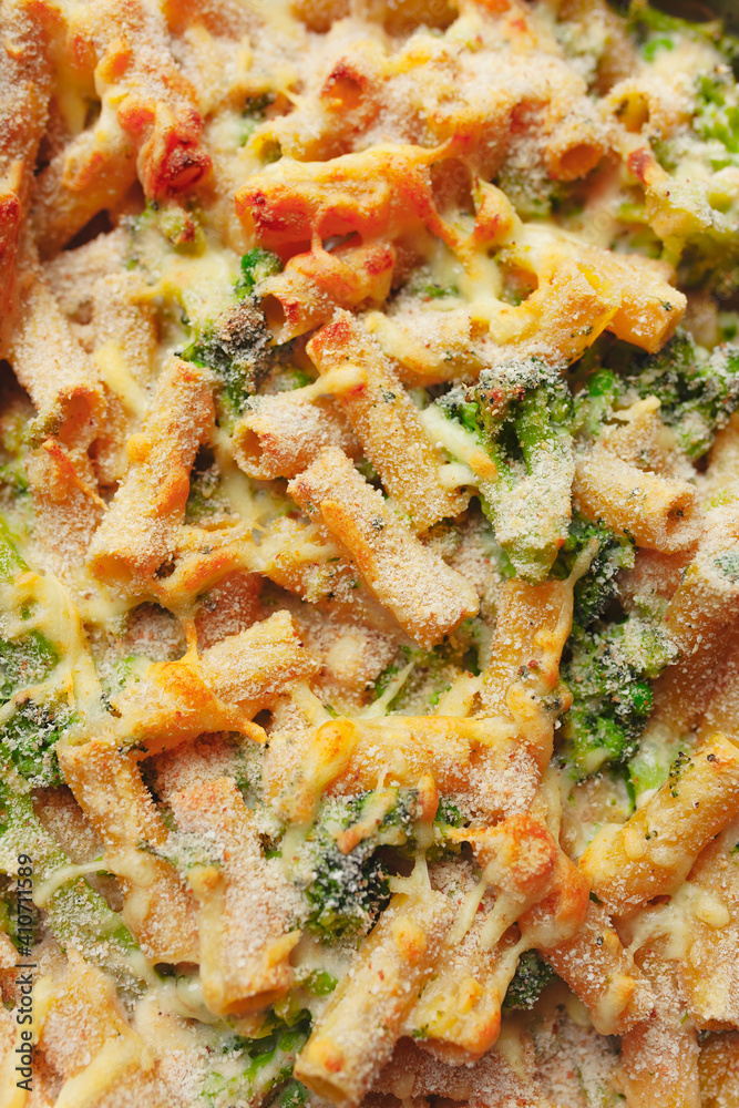Baked pasta casserole with green peas and broccoli, crunchy cheese on top Baked pasta casserole with green peas and broccoli, crunchy cheese on top