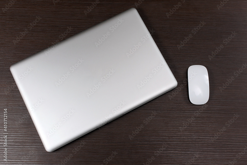 Laptop and mouse on wooden table Laptop and mouse on wooden table