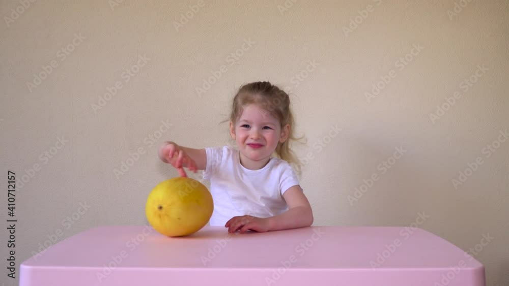 Caucasian girl eating melon. Child and fruit. Food for children. Healthy food. High quality 4k footage Caucasian girl eating melon. Child and fruit. Food for children. Healthy food. High quality 4k footage