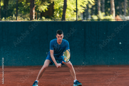 Focused male athlete waiting to receive the ball in a professional tennis game © qunica.com