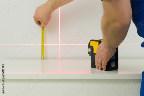 a specialist makes measurements using an electronic laser measuring the angles