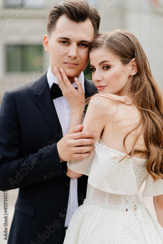 beautiful, gentle and happy bride and groom. woman gently touches man's face