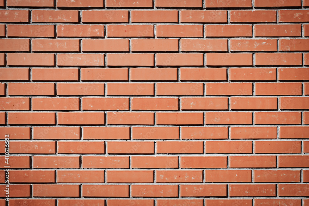 Naklejka premium Red brick wall. Background of a new brick house. Perfect brickwork. Great construction concept.