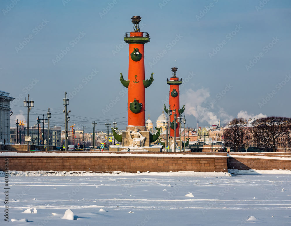 Roman-style columns - Rostralnaya Kolonna on Vasilyevsky island. Sights of St. Petersburg. Winter in the city on the Neva in Russia