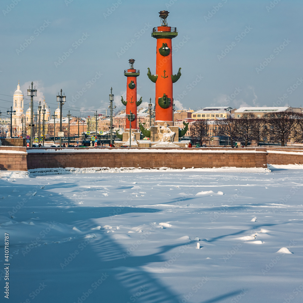 Roman-style columns - Rostralnaya Kolonna on Vasilyevsky island. Sights of St. Petersburg. Winter in the city on the Neva in Russia