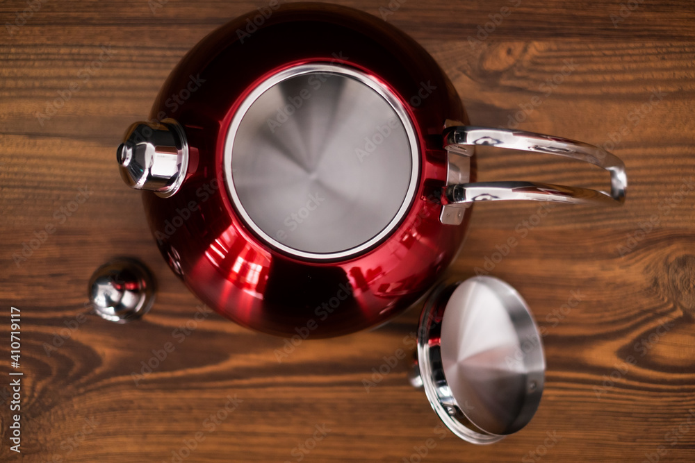 modern Red kettle on wooden background modern Red kettle on wooden background