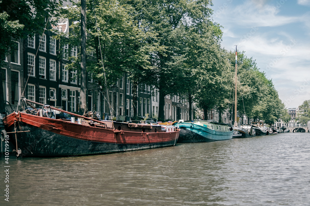 Fototapeta premium Amsterdam canal with historic ships and houses