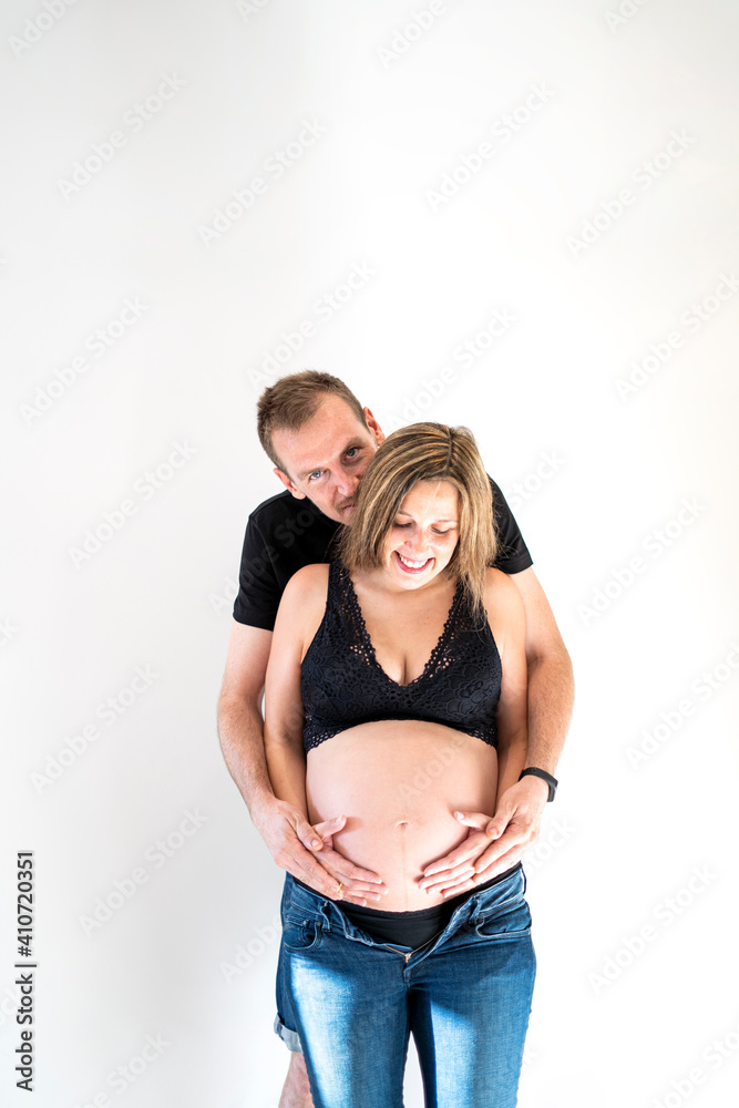 Portrait of young couple kiss and look happy about the pregnancy and the upcoming birth of their baby Portrait of young couple kiss and look happy about the pregnancy and the upcoming birth of their baby
