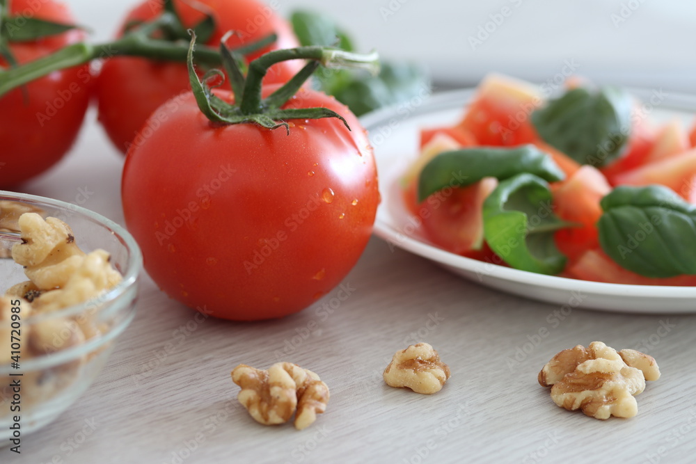 Fresh tomatoes, basil and walnuts as a healthy snack