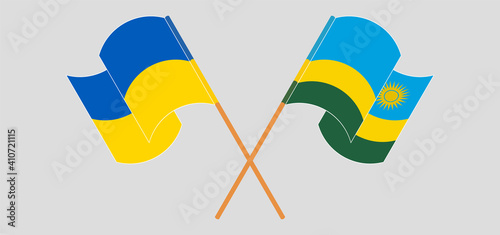 Crossed and waving flags of Ukraine and Rwanda