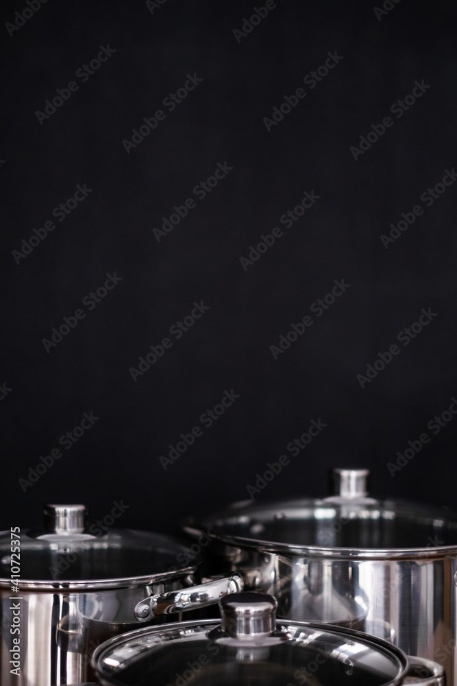 Set of grill pans on wooden table against black background, space for text Set of grill pans on wooden table against black background, space for text