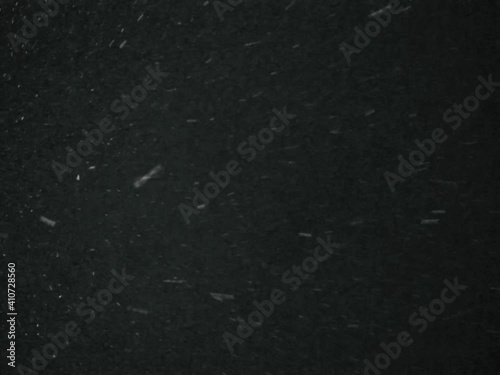 Beautiful real winter snowflakes swirl and fall slowly from a black sky, background, real video
