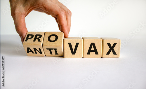 Pro-vax or anti-vax symbol. Doctor turns a cube, changes words 'anti-vax' to 'pro-vax'. Beautiful white background. Copy space. Business, medical covid-19 pro-vax or anti-vax concept.