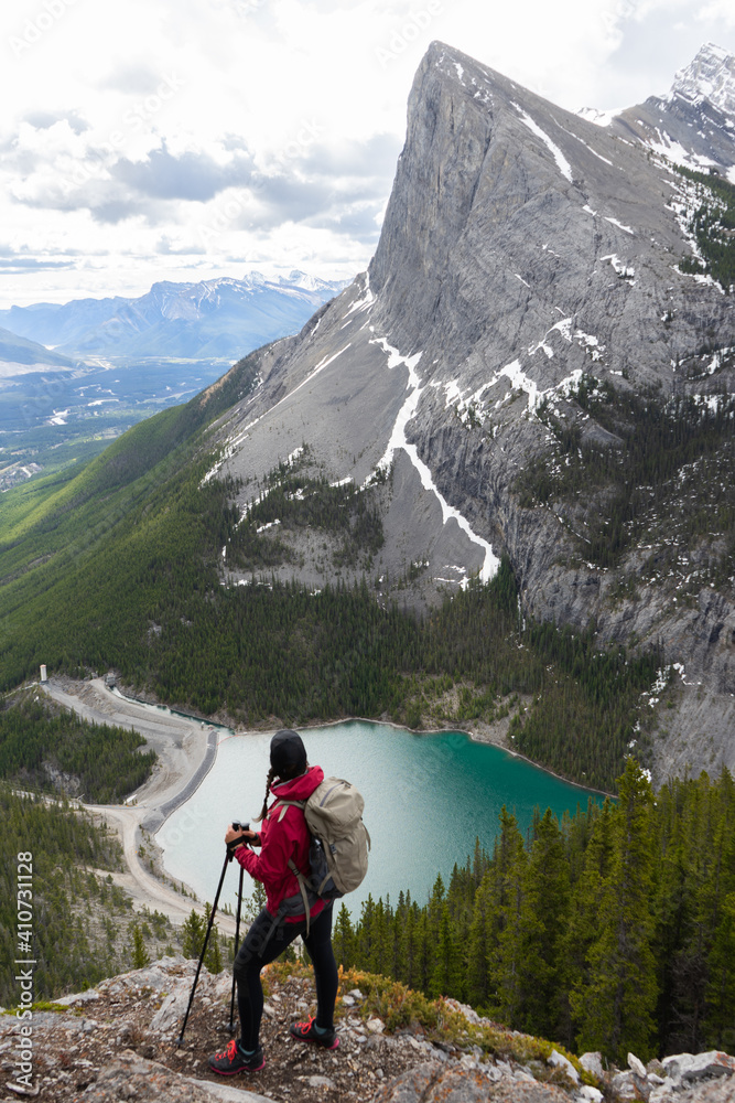 Young active woman hiking East End of Rundle trail in Canadian Rockies. Overlooking Whitemans pond/mountain outdoor landscape. Canmore, Alberta, Canada 