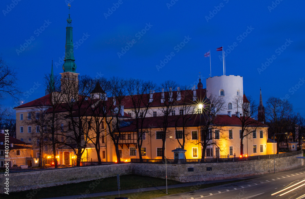 Obraz premium Cityscape to Riga castle is located on the banks of river Daugava, Old Town. Rigas pils official residence of president and Museum of History with illumination on night. RIGA Capital of Latvia.