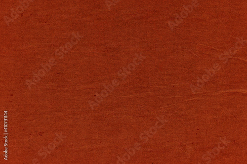 Cardboard red abstract pattern texture close-up. Retro old paper background. Grunge concrete wall. Vintage blank wallpaper.