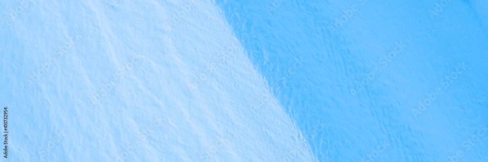 Snow texture. Wind sculpted patterns on snow surface. Wind in the tundra and in the mountains on the surface of the snow sculpts patterns and ridges. Arctic, Polar region. Winter panoramic background. Snow texture. Wind sculpted patterns on snow surface. Wind in the tundra and in the mountains on the surface of the snow sculpts patterns and ridges. Arctic, Polar region. Winter panoramic background.