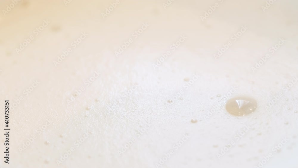 Milk foam in a cappuccino. Cup of hot coffee. Beige bubbles in beverage. Milk foam in a cappuccino. Cup of hot coffee. Beige bubbles in beverage.