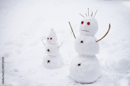 Two little snowmen having fun at winter.