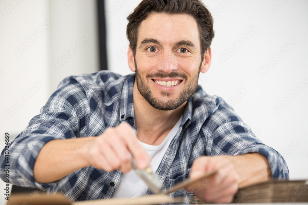 middle age handsome carpenter posing in workshop middle age handsome carpenter posing in workshop