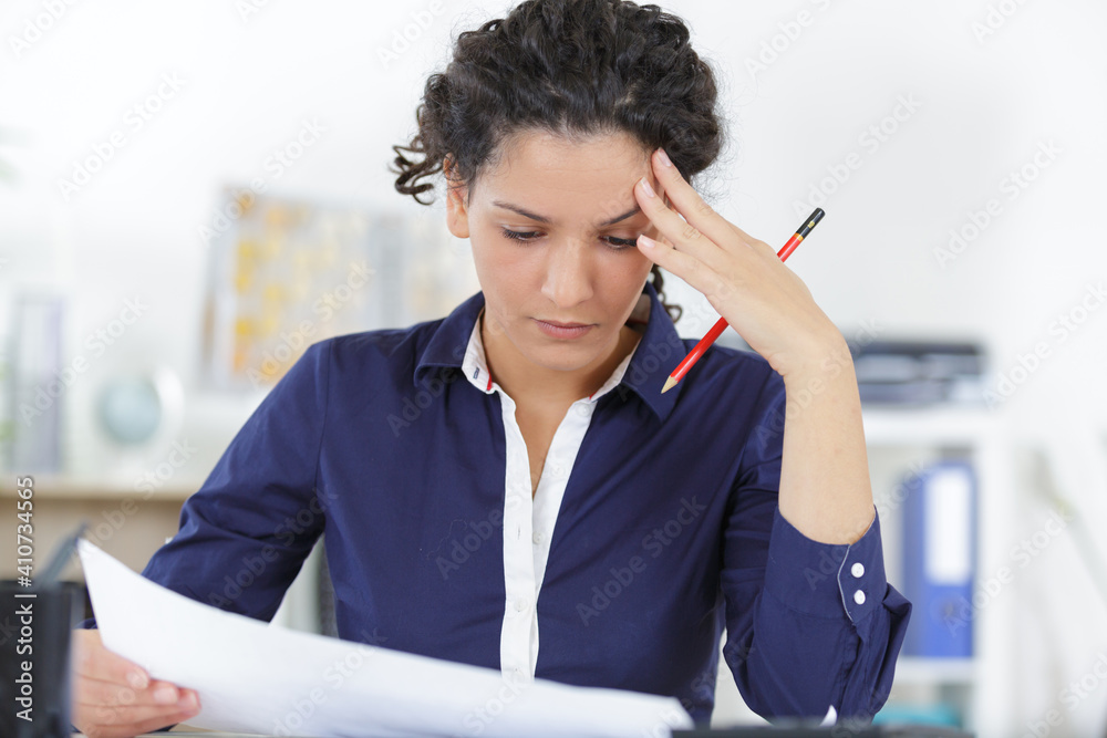 woman working with blueprint near the window in office woman working with blueprint near the window in office