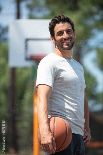 full length portrait of a handsome basketball player standing © auremar