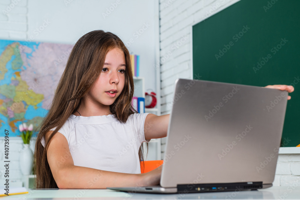 cheerful kid girl with computer at school lesson, e learning cheerful kid girl with computer at school lesson, e learning