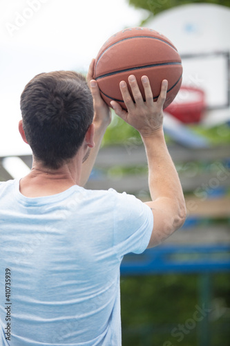 portrait of a basketball player taking a jump shot © auremar