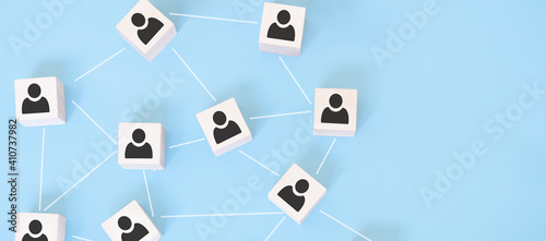 Organization structure, team building, business management or human resources concepts. Person icons on wooden cubes linked to each other.