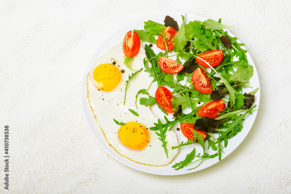 Breakfast - fried eggs and fresh vegetables. Top view Breakfast - fried eggs and fresh vegetables. Top view