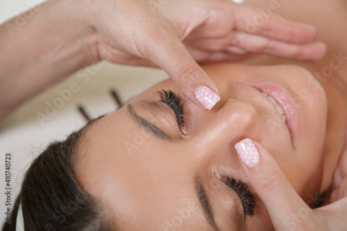 Cropped close up of a woman enjoying anti-aging face massage