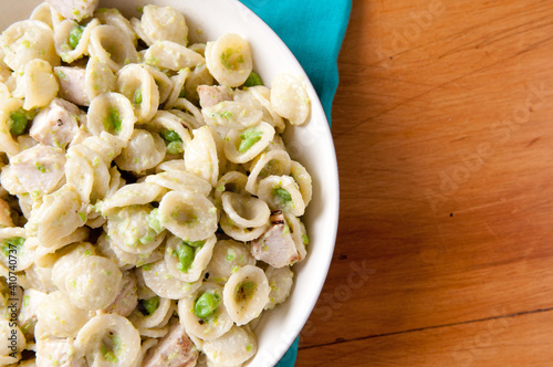 peas and pesto sauce with chicken over orecchiette photo
