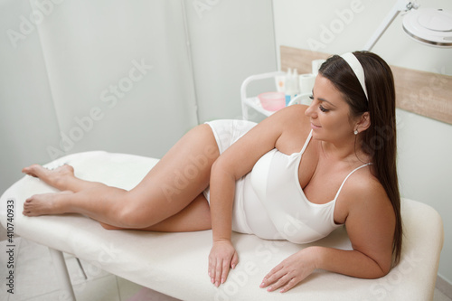 Gorgeous plus size curvy woman resting at beauty spa at cosmetology treatment