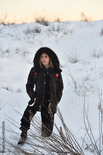 a beautiful young caucasian girl posing in the snow