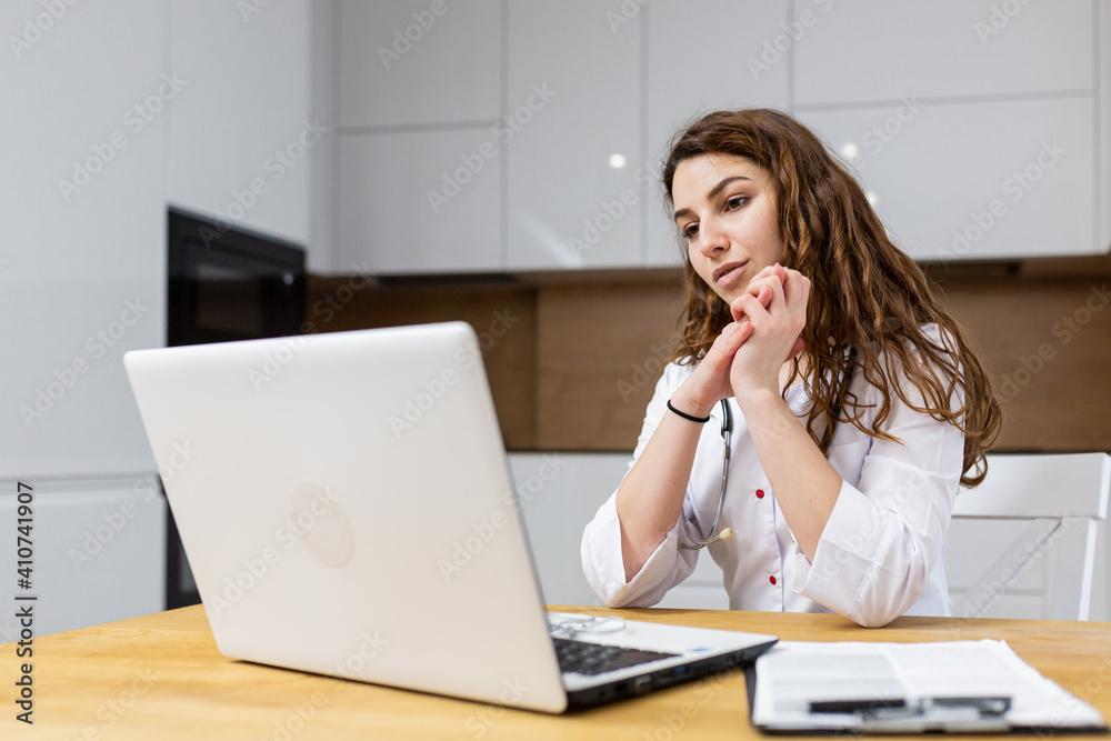 portrait of female doctor talking online with patient, making video call, looking at camera, young woman wearing white uniform with stethoscope portrait of female doctor talking online with patient, making video call, looking at camera, young woman wearing white uniform with stethoscope