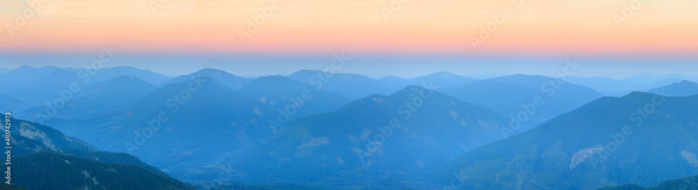 Mountain outline on morning sky background. Summer daybreak misty top view (Gorgany, Carpathians, Ukraine). 