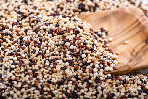 Red, white and brown quinoa seeds background 