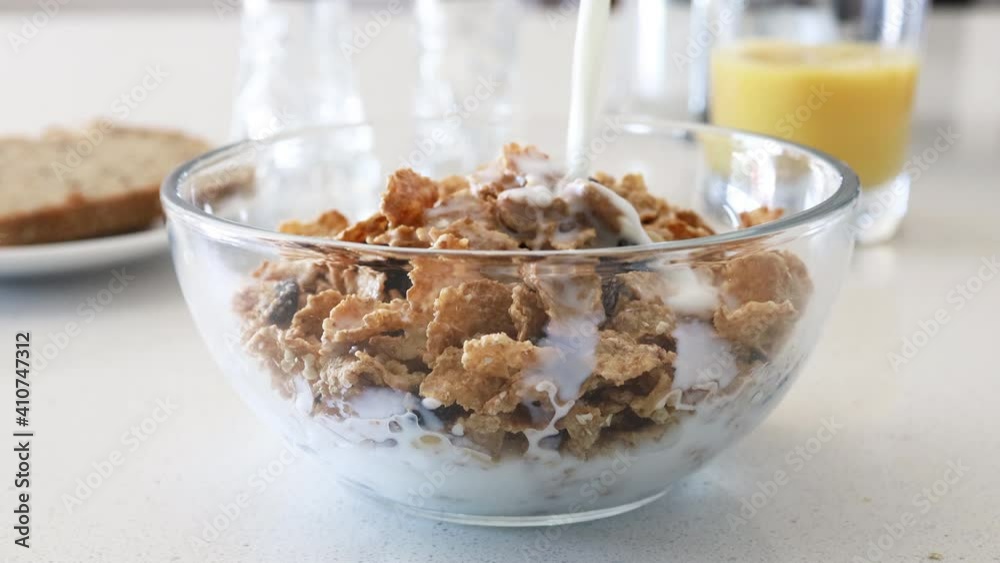 Pouring Milk over a Bowl of Cereal Pouring Milk over a Bowl of Cereal