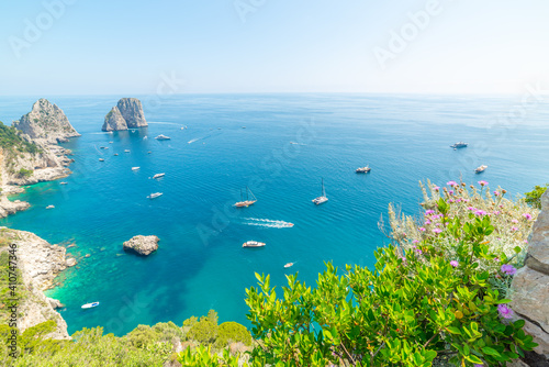 Boats by world famous Capri sea stacks on a clear day