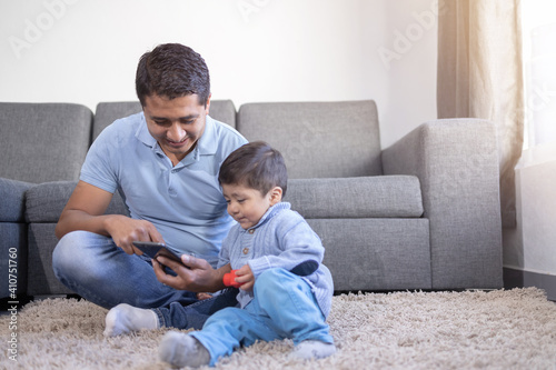 Mexican father and child doing video call at home, father's day 