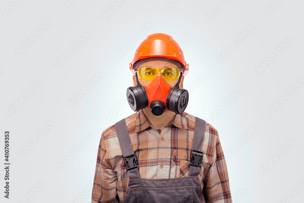 Portrait of handyman in protective work equipment is looking to the camera.