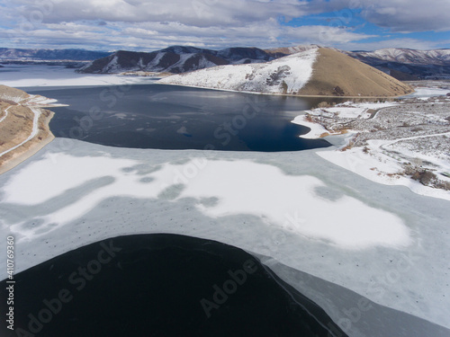 ice thaw on a lake, winter, aerial photo of a frozen lake