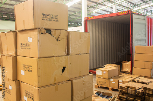 unloading carton from container and carton damage from loading or transport process.  photo