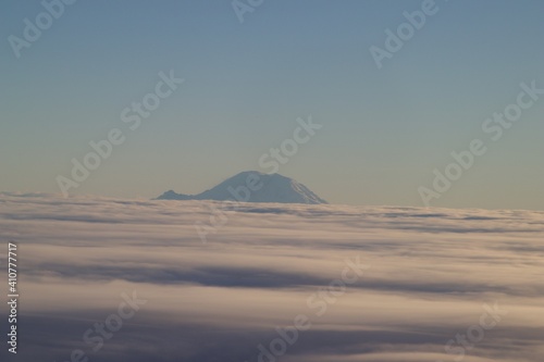 Mount Rainier emerging from the clouds, viewed from a plane, Washington, USA