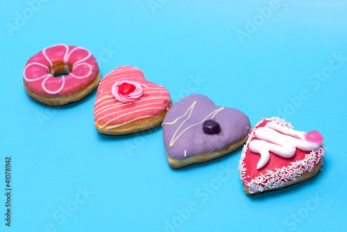 An assorted dozen donuts in a box isolated on a blue background