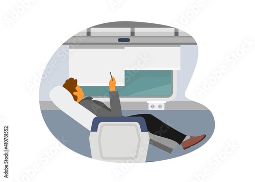 Male passenger sitting on a train car seat with leg rest.